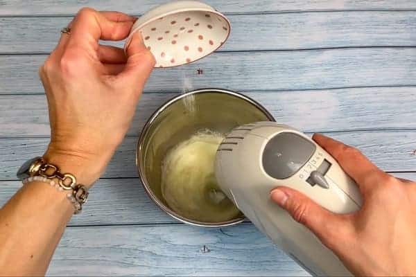 Für das Kokosmakronen Rezept werden Eiweiß und eine Prise Salz mit einem Handmixer zu Eischnee geschlagen