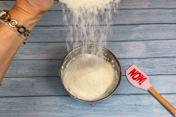 Kokosraspeln werden zu dem mit Chunky Flavour und Erythrit gesüßtem Eischnee in eine Schüssel gegeben.