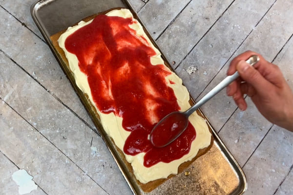 Low carb Tiramisu wird mit zuckerfreier Erdbeersoße bestrichen.