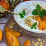 Vegane Bowl mit Skyr, Aprikosen und Sojaflocken mit frischer Minze dekoriert.